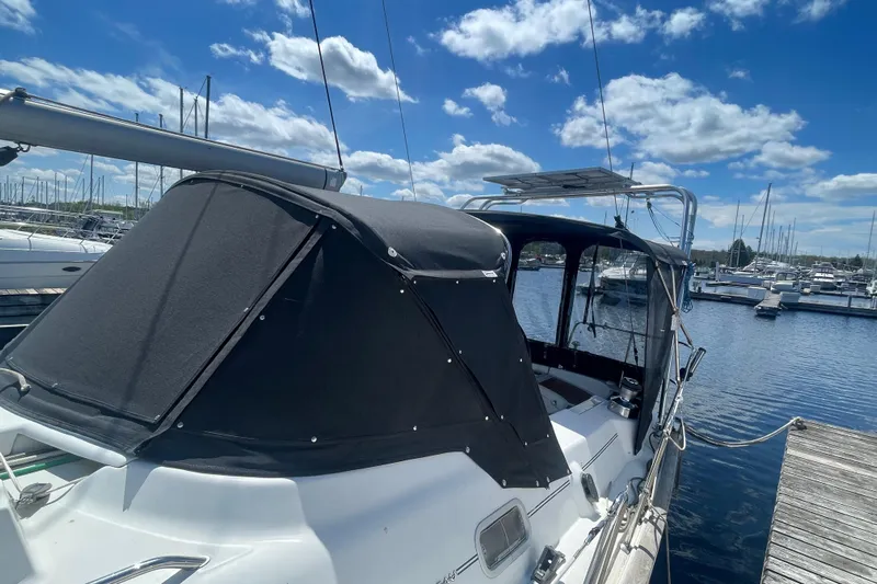 Still In The Moment Yacht Photos Pics 2007 Beneteau 423 sailboat docked at marina under blue sky.