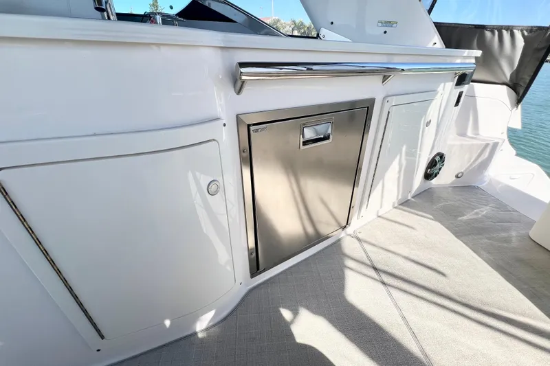Aventuras Yacht Photos Pics 2021 Regal 33 XO boat interior with stainless steel drawer and storage compartments.
