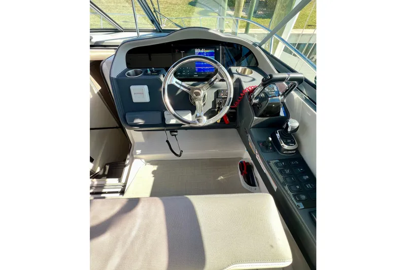 Aventuras Yacht Photos Pics 2021 Regal 33 XO boat helm with steering wheel and control panel.