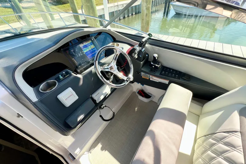 Aventuras Yacht Photos Pics 2021 Regal 33 XO boat helm with modern controls and navigation display.