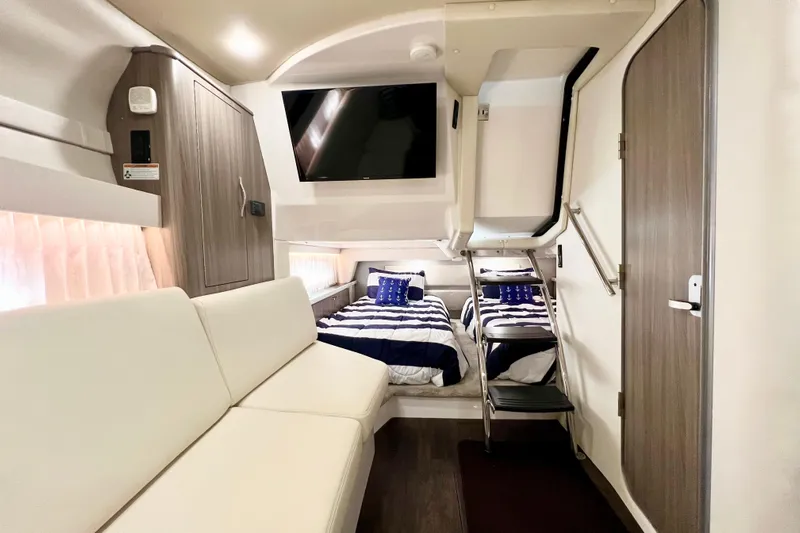 Aventuras Yacht Photos Pics Interior of 2021 Regal 33 XO yacht with modern seating and cozy sleeping area.