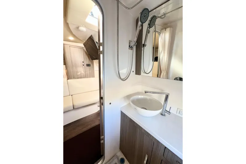 Aventuras Yacht Photos Pics 2021 Regal 33 XO yacht bathroom with modern sink and showerhead.