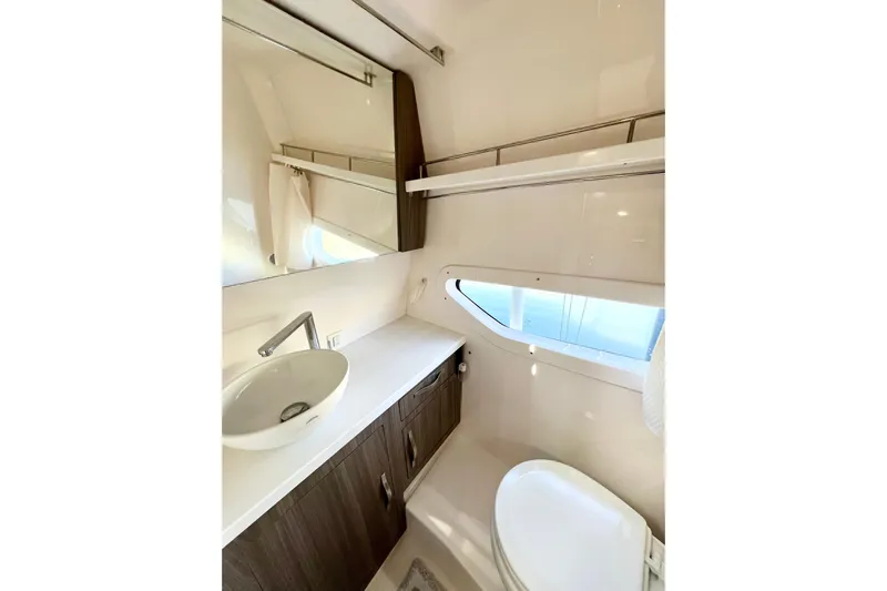 Aventuras Yacht Photos Pics 2021 Regal 33 XO yacht bathroom with modern sink, mirror, and window.