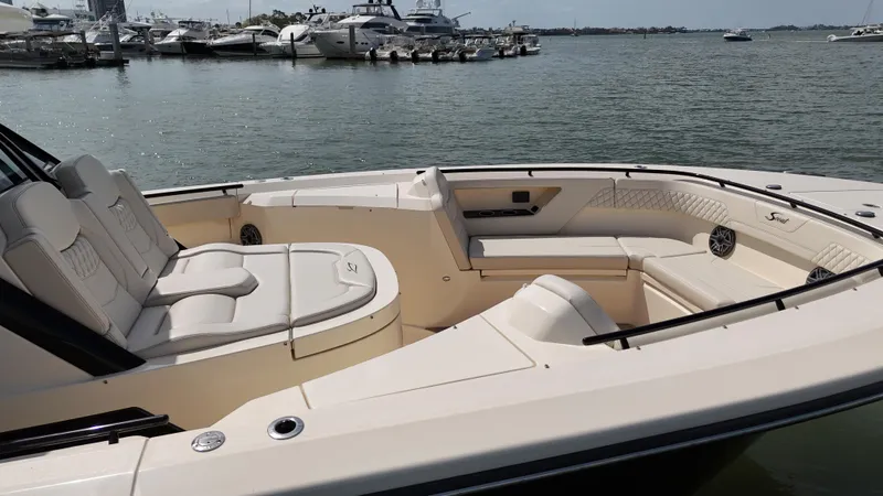  Yacht Photos Pics 2024 Scout 377 LXF luxury boat interior with spacious seating, docked in a marina.