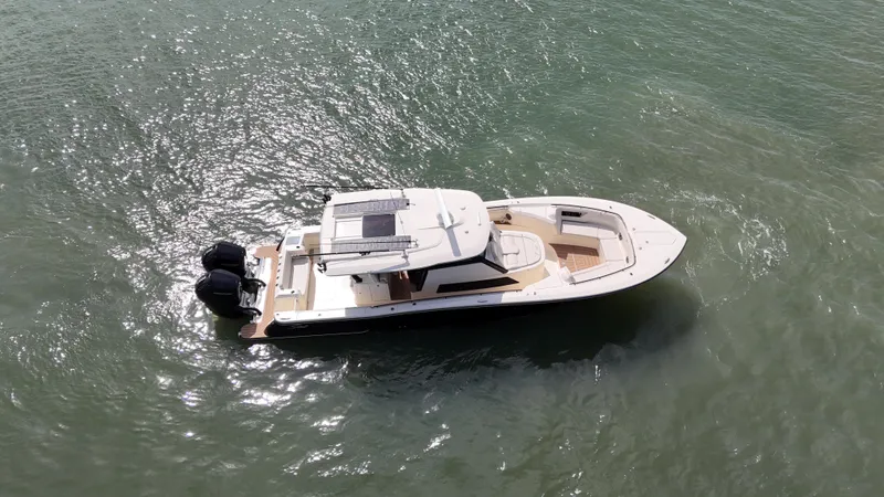  Yacht Photos Pics 2024 Scout 377 LXF boat on water, aerial view, showcasing sleek design and twin engines.
