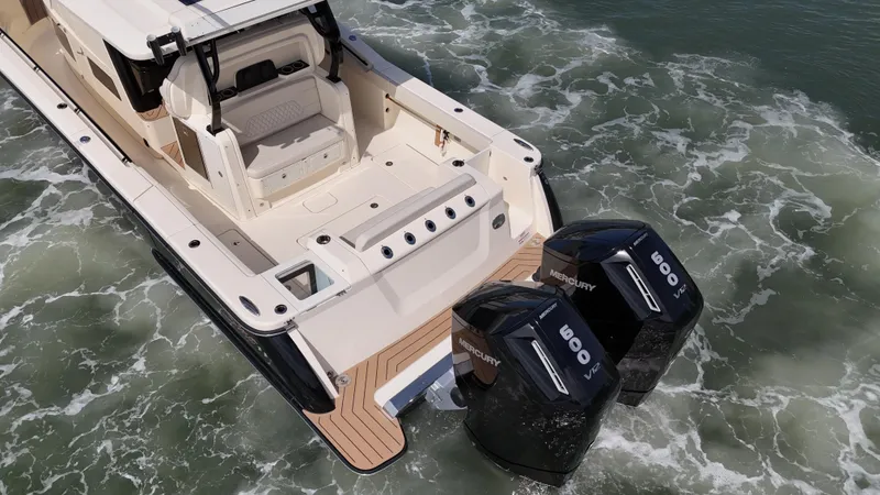  Yacht Photos Pics 2024 Scout 377 LXF boat with dual Mercury engines in water.