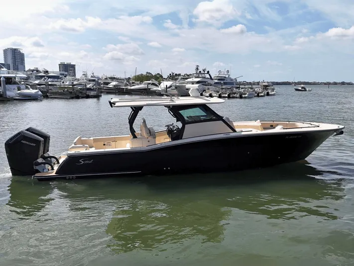  Yacht Photos Pics 2024 Scout 377 LXF boat docked in marina, featuring sleek design and powerful engines.