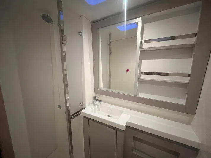  Yacht Photos Pics Modern bathroom in 2022 Fountaine Pajot Elba 45 yacht with sleek fixtures and mirror.