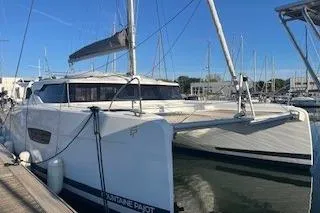  Yacht Photos Pics 2022 Fountaine Pajot Elba 45 catamaran docked in a marina under clear blue skies.