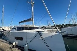  Yacht Photos Pics 2022 Fountaine Pajot Elba 45 catamaran docked at marina under clear blue sky.