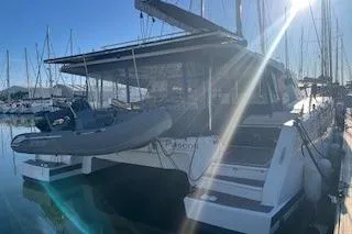  Yacht Photos Pics 2022 Fountaine Pajot Elba 45 catamaran docked in a sunny marina.