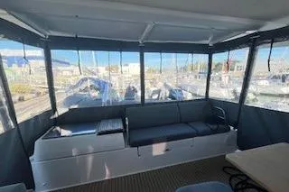  Yacht Photos Pics 2022 Fountaine Pajot Elba 45 catamaran interior with seating and marina view.
