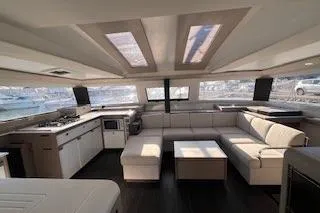  Yacht Photos Pics Luxurious interior of 2022 Fountaine Pajot Elba 45 catamaran with modern kitchen and seating area.