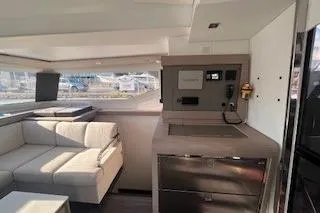  Yacht Photos Pics Interior of 2022 Fountaine Pajot Elba 45 yacht with modern seating and kitchen area.