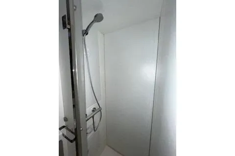  Yacht Photos Pics Shower area in 2022 Fountaine Pajot Elba 45 yacht, featuring modern fixtures and white walls.