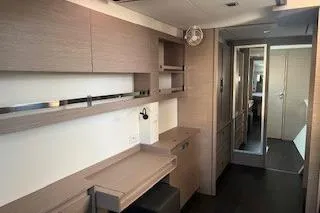  Yacht Photos Pics Interior of 2022 Fountaine Pajot Elba 45 catamaran, featuring modern wood cabinetry and sleek design.