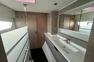  Yacht Photos Pics Modern bathroom interior of 2022 Fountaine Pajot Elba 45 catamaran, featuring sleek design and ample lighting.