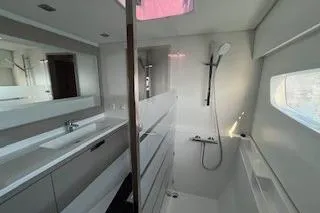  Yacht Photos Pics Modern bathroom interior of 2022 Fountaine Pajot Elba 45 yacht, featuring sleek design and fixtures.