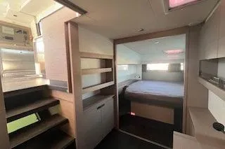  Yacht Photos Pics Interior of 2022 Fountaine Pajot Elba 45 catamaran, featuring modern bedroom and staircase.