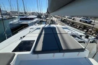  Yacht Photos Pics 2022 Fountaine Pajot Elba 45 catamaran docked at marina, showcasing spacious deck.