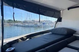  Yacht Photos Pics 2022 Fountaine Pajot Elba 45 interior with marina view through large window.