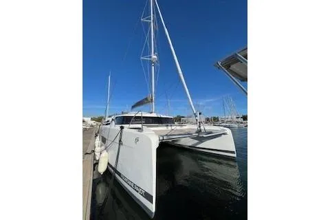  Yacht Photos Pics 2022 Fountaine Pajot Elba 45 catamaran docked at marina under clear blue sky.