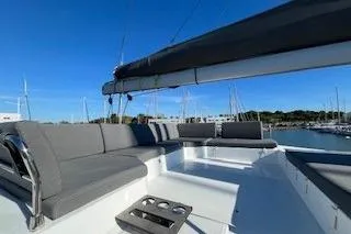  Yacht Photos Pics 2022 Fountaine Pajot Elba 45 catamaran with spacious deck and seating, docked in marina.
