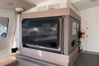  Yacht Photos Pics Interior of 2022 Fountaine Pajot Elba 45 yacht with modern TV setup.