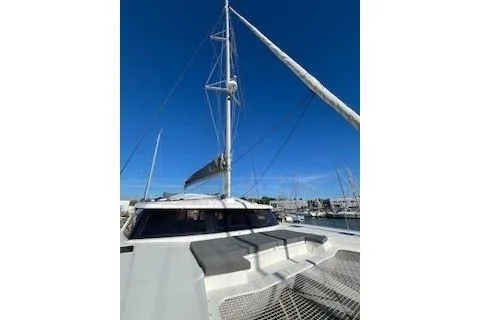  Yacht Photos Pics 2022 Fountaine Pajot Elba 45 catamaran with sails, docked under clear blue sky.