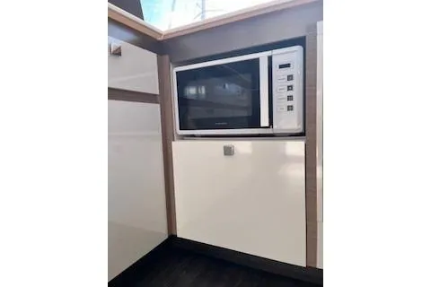  Yacht Photos Pics Modern kitchen with built-in microwave on 2022 Fountaine Pajot Elba 45 yacht.