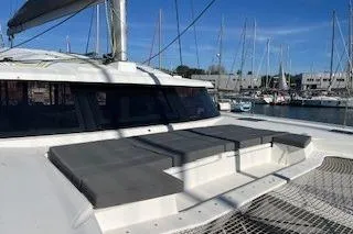  Yacht Photos Pics 2022 Fountaine Pajot Elba 45 catamaran docked in marina, featuring spacious deck seating.