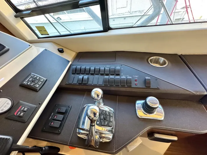 Bateau D’amis Yacht Photos Pics Control panel of a 2016 Sea Ray 510 Fly yacht with switches and throttle levers.