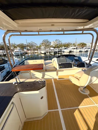 Bateau D’amis Yacht Photos Pics 2016 Sea Ray 510 Flybridge with luxurious seating and marina view.