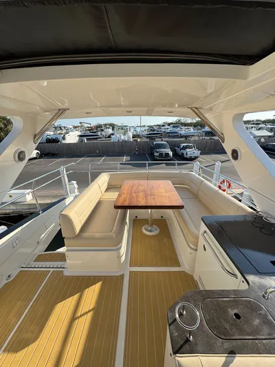 Bateau D’amis Yacht Photos Pics 2016 Sea Ray 510 Fly yacht interior with seating and table on deck.