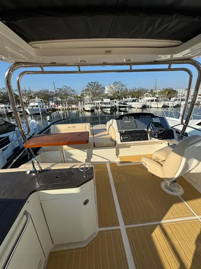 Bateau D’amis Yacht Photos Pics 2016 Sea Ray 510 Flybridge with luxurious seating and modern helm at marina.