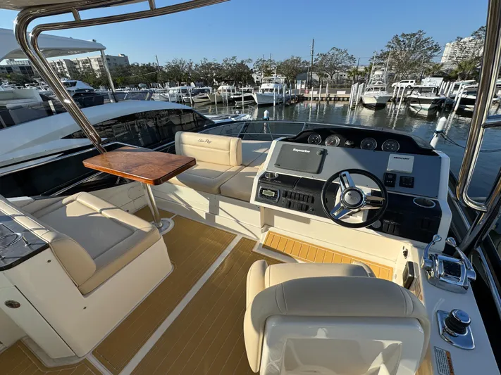 Bateau D’amis Yacht Photos Pics 2016 Sea Ray 510 Fly yacht interior with helm, seating, and table at marina.