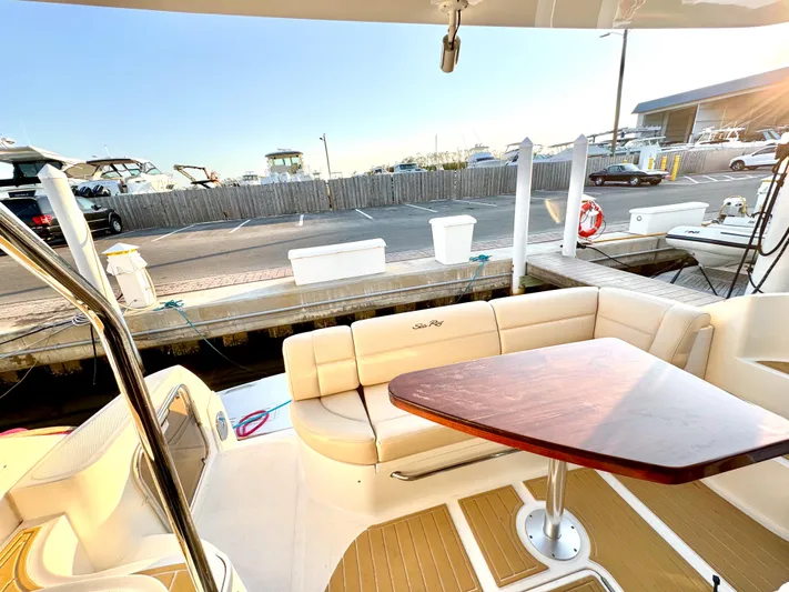 Bateau D’amis Yacht Photos Pics Luxurious 2016 Sea Ray 510 Fly yacht with elegant outdoor seating and wooden table.