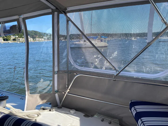  Yacht Photos Pics View from a 2001 Catalina 42 MkII sailboat cockpit with water and shoreline in the background.