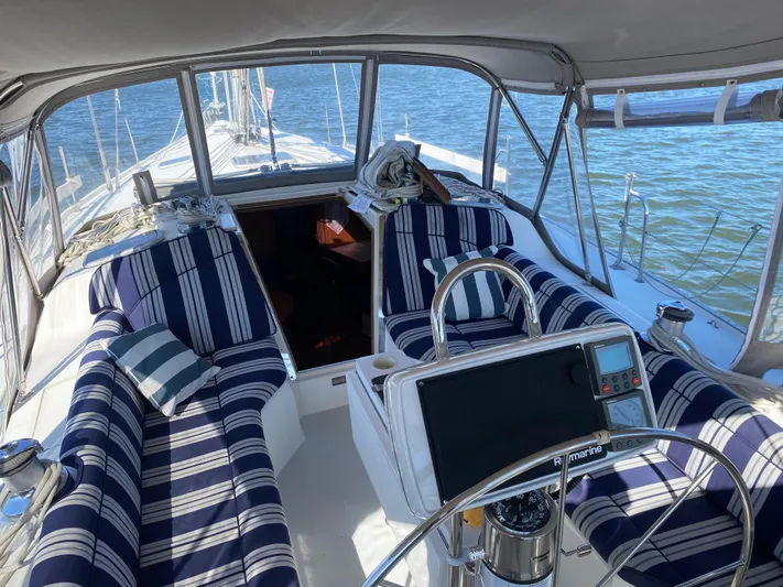  Yacht Photos Pics Cockpit of 2001 Catalina 42 MkII sailboat with striped seating and navigation equipment.