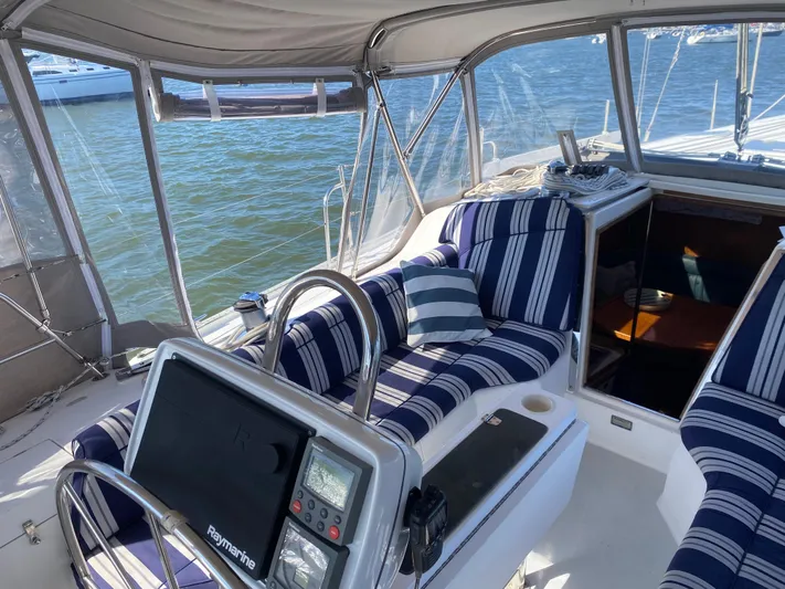  Yacht Photos Pics Cockpit of 2001 Catalina 42 MkII sailboat with striped seating and navigation equipment.