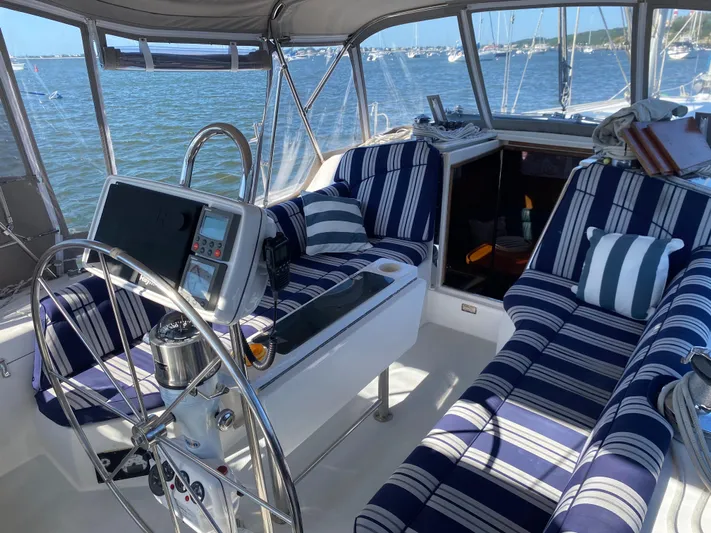  Yacht Photos Pics Cockpit of 2001 Catalina 42 MkII sailboat with striped cushions and steering wheel.