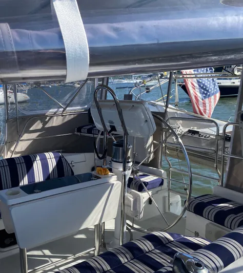  Yacht Photos Pics 2001 Catalina 42 MkII sailboat cockpit with striped seating and American flag.
