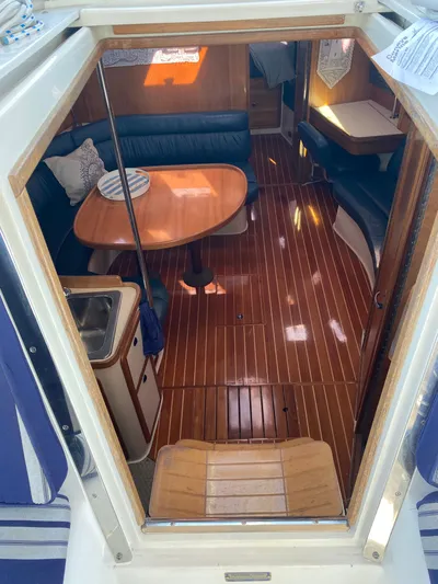  Yacht Photos Pics Interior of 2001 Catalina 42 MkII sailboat with polished wood flooring and dining area.
