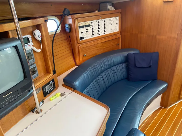  Yacht Photos Pics 2001 Catalina 42 MkII yacht interior with blue seating and navigation equipment.