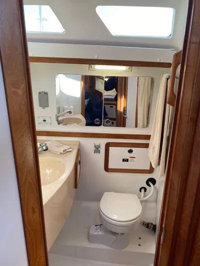  Yacht Photos Pics 2001 Catalina 42 MkII yacht bathroom with sink, toilet, and mirror.