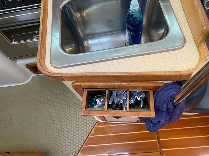 Yacht Photos Pics Galley sink area in 2001 Catalina 42 MkII yacht with utensils and dish soap.