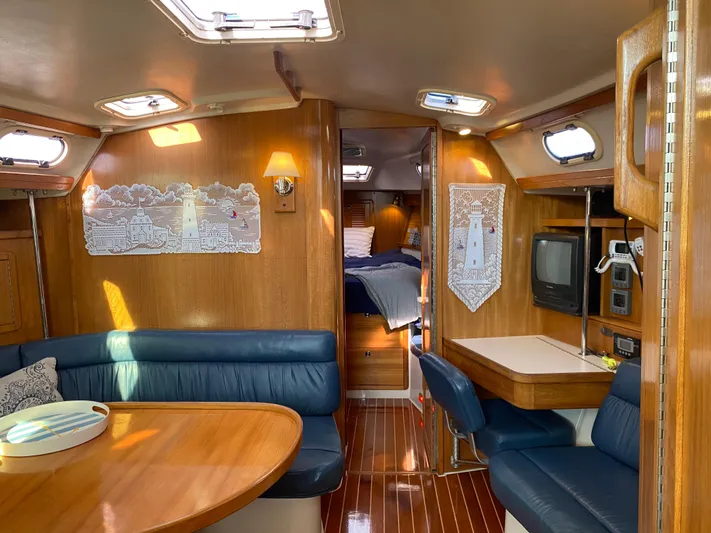  Yacht Photos Pics Interior of 2001 Catalina 42 MkII sailboat with wood finish and blue seating.