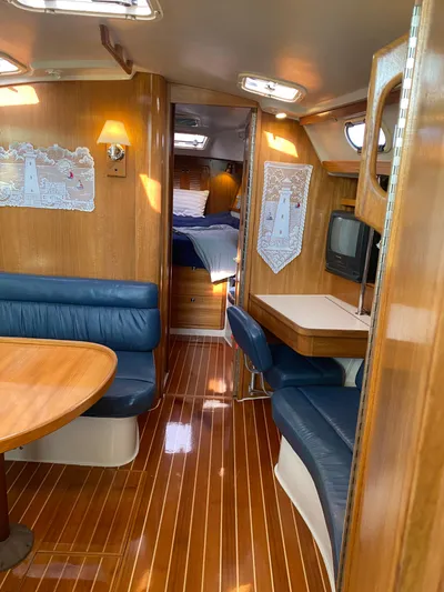  Yacht Photos Pics Interior of 2001 Catalina 42 MkII sailboat with wood finish and blue seating.