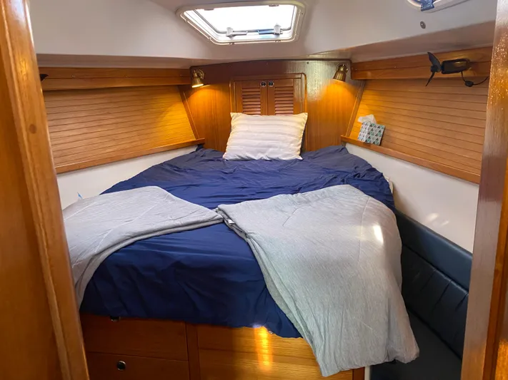  Yacht Photos Pics Cozy cabin interior of 2001 Catalina 42 MkII sailboat with wooden paneling and bedding.