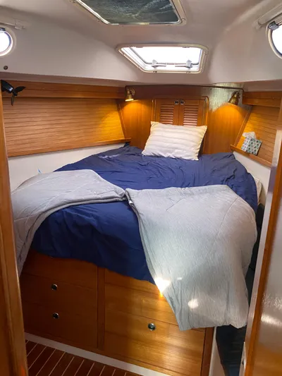  Yacht Photos Pics Cozy cabin interior of 2001 Catalina 42 MkII sailboat with bed and wooden accents.